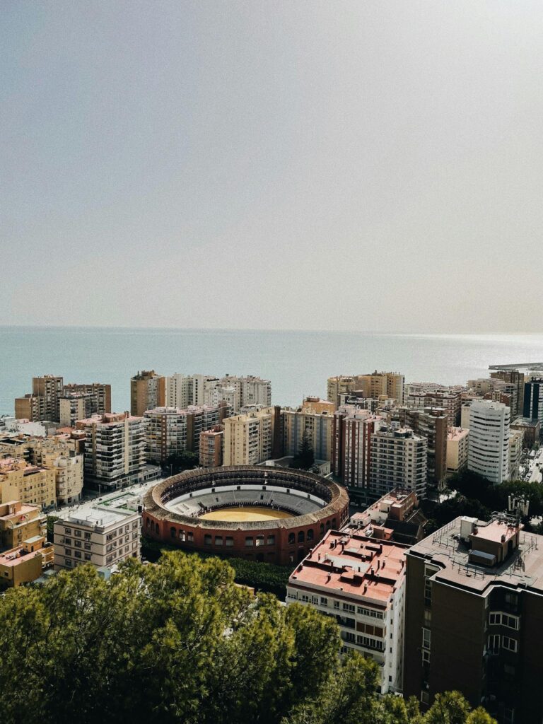 Discover Málaga's vibrant cityscape with its iconic bullring and coastal horizon in view.
